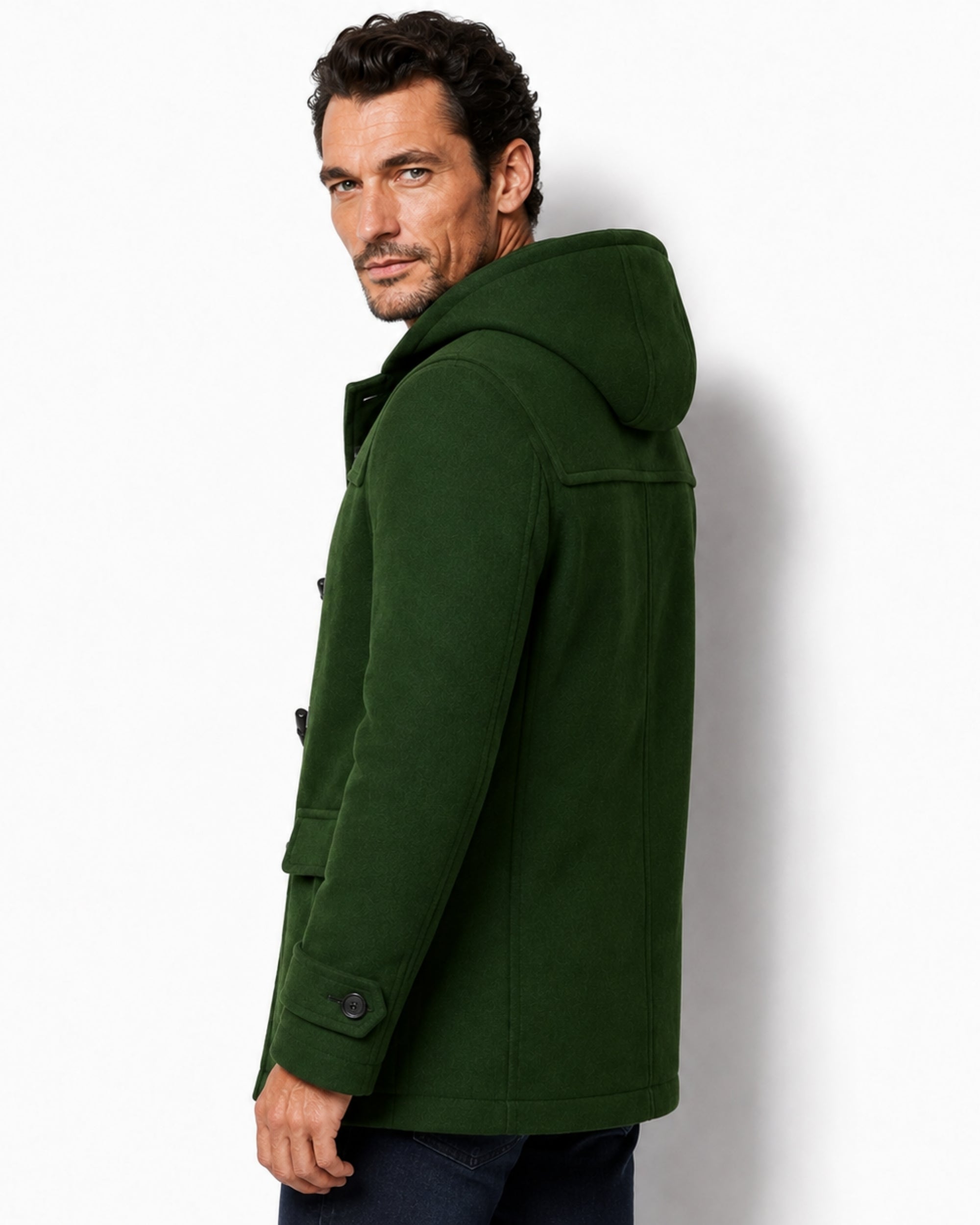 Side profile of the men's green wool toggle coat, highlighting the deep hood and adjustable buttoned cuff straps.